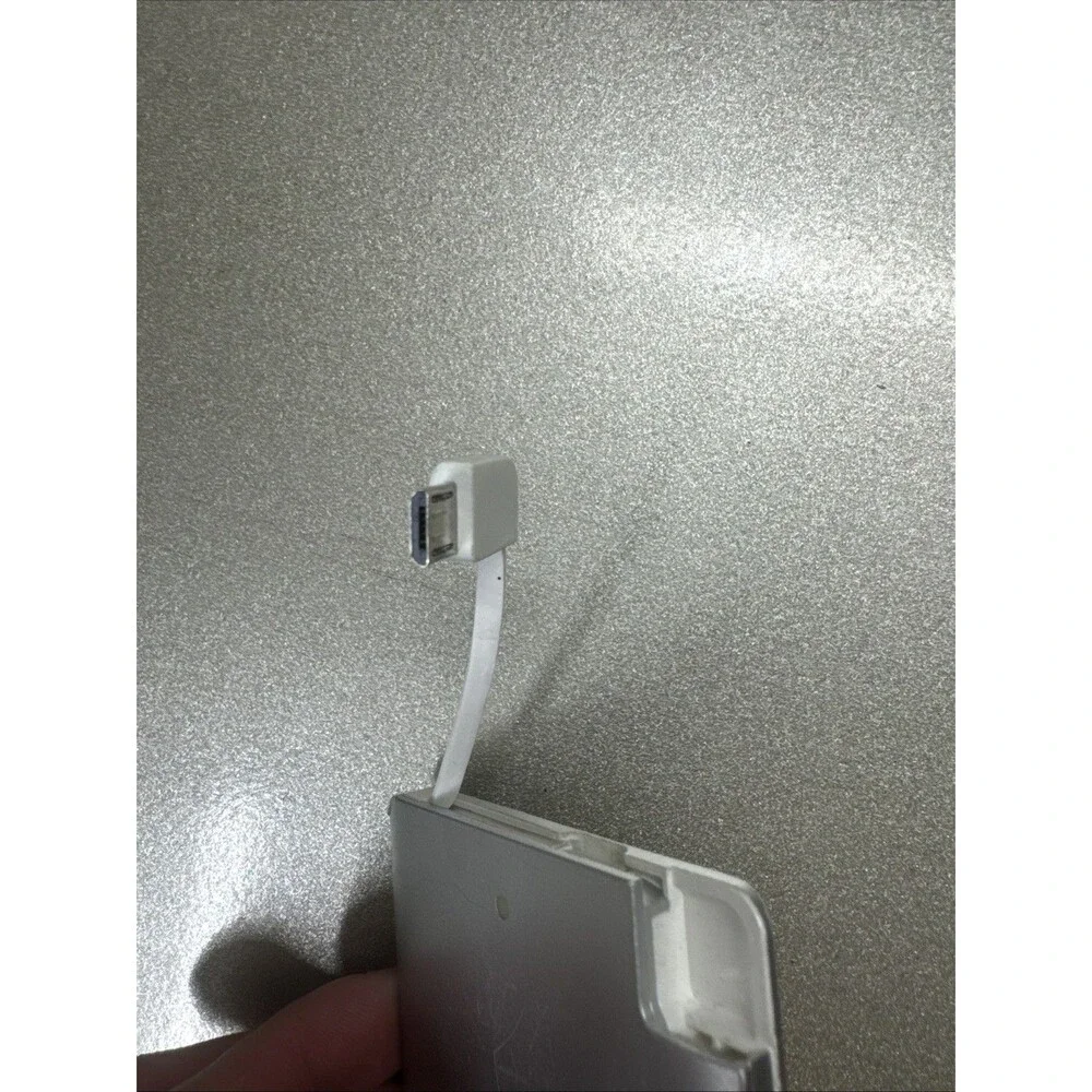 Ultra Slim portable charger silver with looks like Micro-USB cord see photos